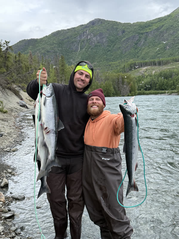 Anglers with bright silver salmon on the Kenai River